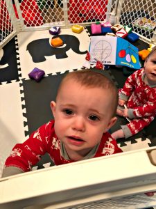 unhappy baby in play yard