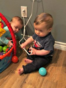 baby plays with cords